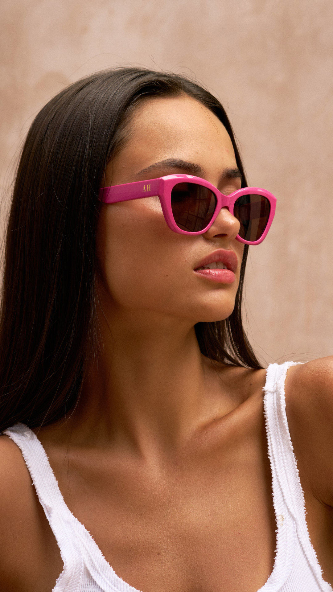 ANEA HILL pink luxuery sunglasses that are sunglasses for women. Best luxury brand sunglasses that fit smaller faces and are adjustable. Gold AH logo on the side of the sunglasses