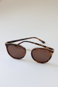 Close-up of Anea Hill brand name etched on lens of Sunglasses