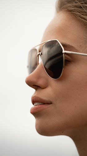 woman wearing high end Sunglasses in aviator shape 