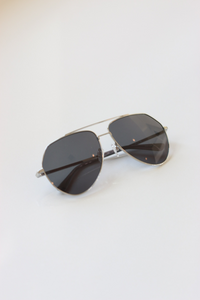 Sail Silver Aviator Sunglasses from ANEA HILL - a luxurious fashion accessory with a silver-tone metal frame, dark-gray tinted lenses, and exquisite attention to detail.