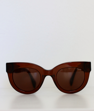 Load image into Gallery viewer, Front view of see-through brown sunglasses.
