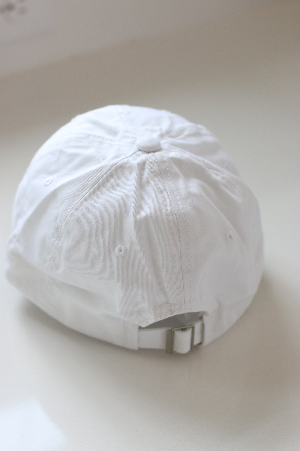 Back of baseball cap, showing adjustable feature.