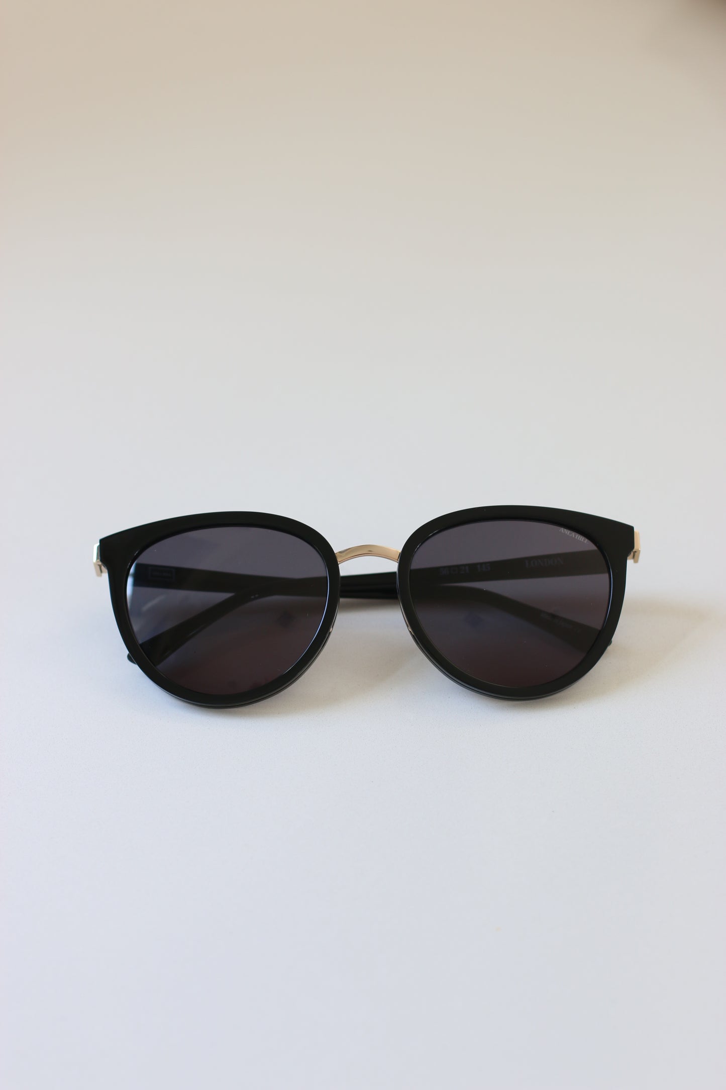 A classic and timeless pair of luxury sunglasses from London with a black frame and grey tinted lenses.
