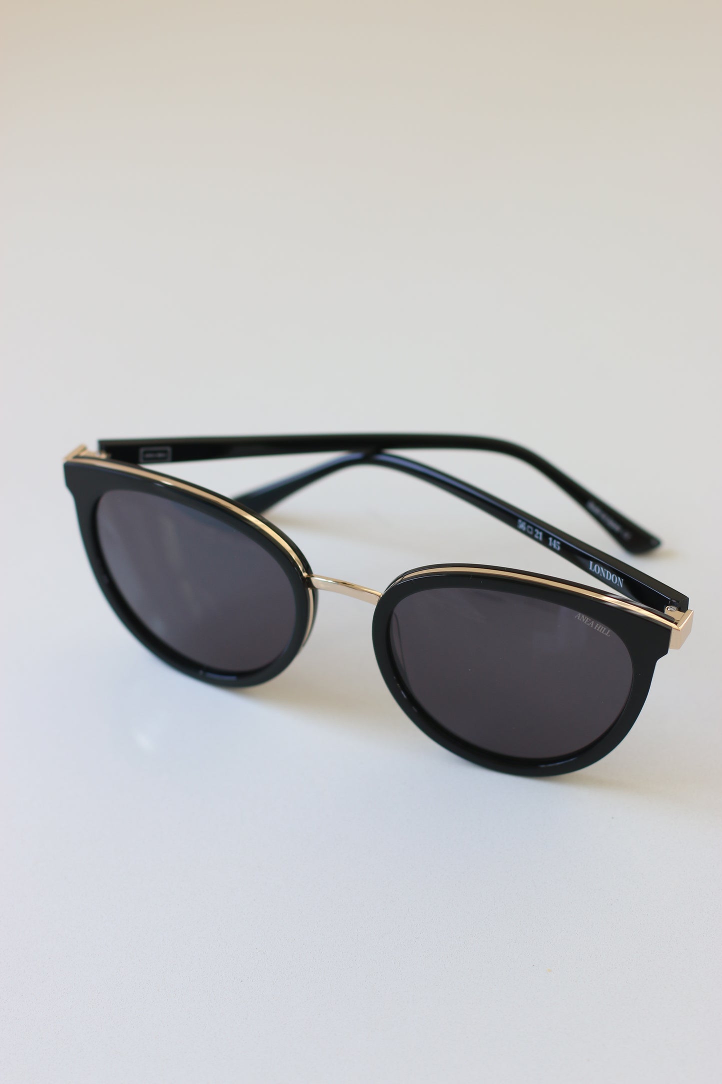 These stylish and elegant sunglasses boast a unique cat-eye shape and gold detailing for a glamorous look.