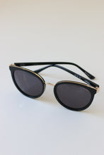 Load image into Gallery viewer, These stylish and elegant sunglasses boast a unique cat-eye shape and gold detailing for a glamorous look.
