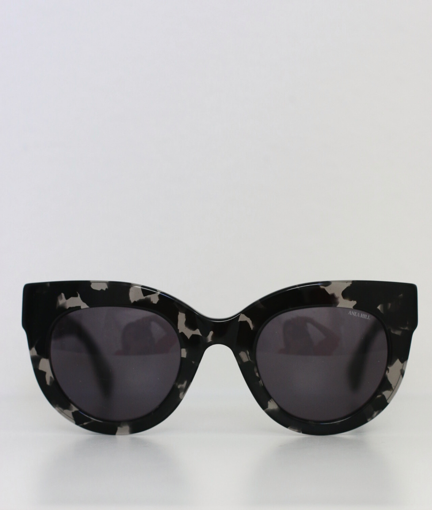 Handcrafted high-end women's sunglasses featuring oversized cat-eye frames with clear tortoise acetate material