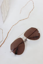 Load image into Gallery viewer, Anea hill&#39;s yacht gold sunglasses are UV protected with a brown lens
