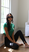 Load image into Gallery viewer, Model in luxury oversized sunglasses, wearing Anea Hill Manhattan sunglasses, sitting on the floor and in the sun
